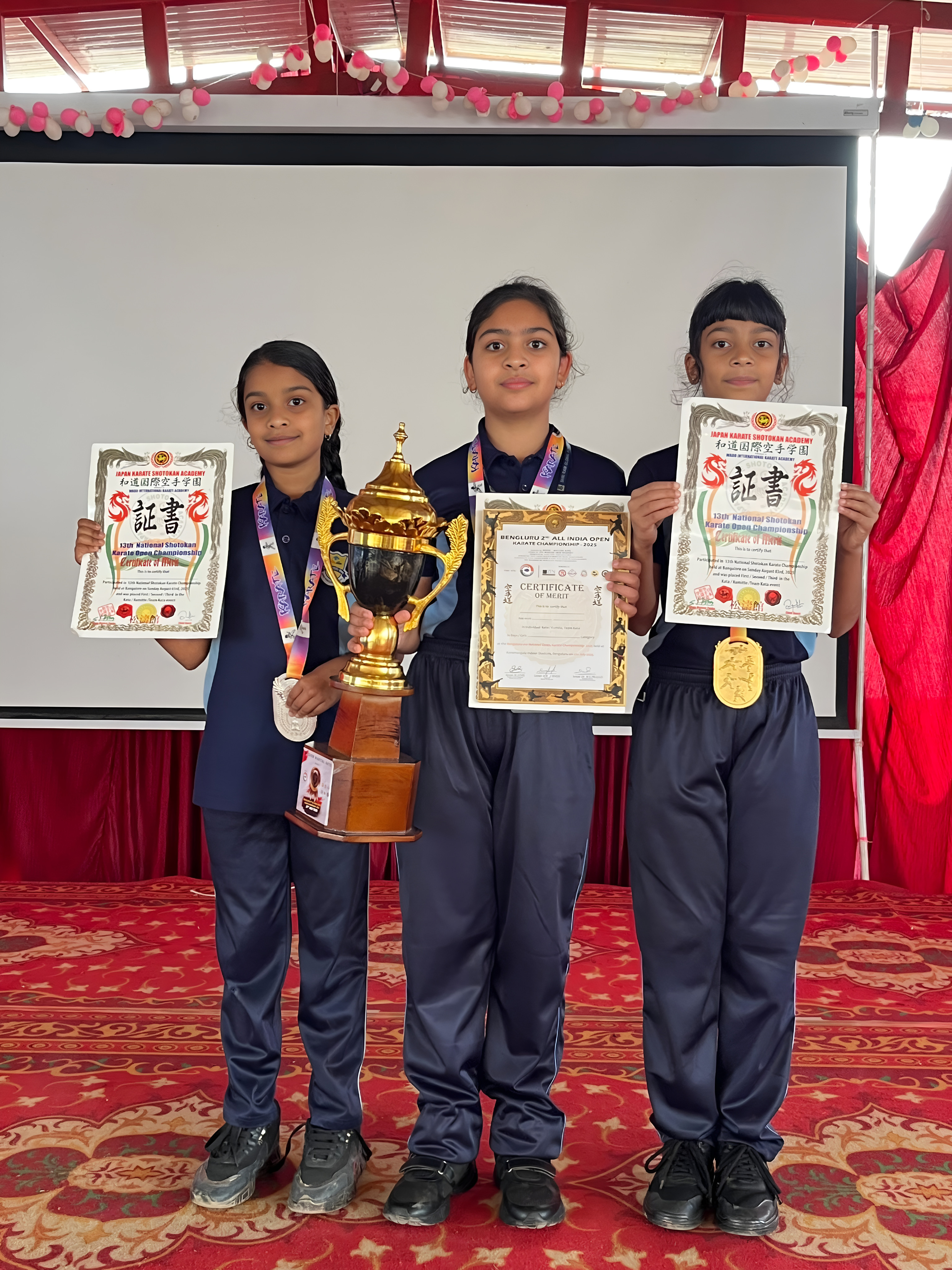National Shotokan medalists with certificates and trophy